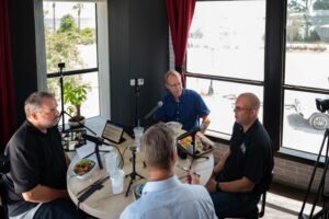 Kevin Elliot (his back to the camera), Fletcher Isacks and Jason Hedden listen to Daniel Henderson form BFG Productions outline his plans for growing his entertainment booking agency